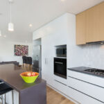 the quality of the finishes is on show with the granite benchtop, tiled splashback and contrasting joinery