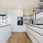 the timber floors and simple white laminate cabinetry give a clean modern look